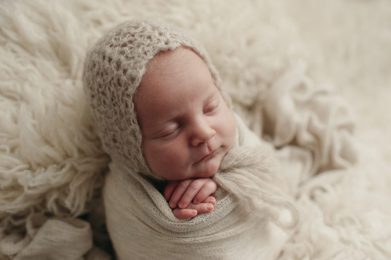newborn wrapped in white blanket and crochet hat- Clients' Kind words & Reviews