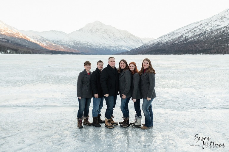 Family stands together during Eklutna Lake winter family session