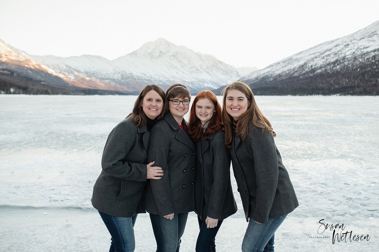 Mom and 3 daughters lean in together