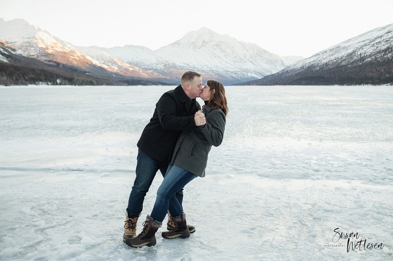dad steals a kiss from mom during winter family session