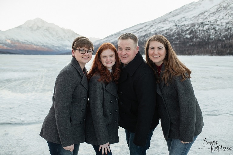 Dad and his 3 daughters leans in together