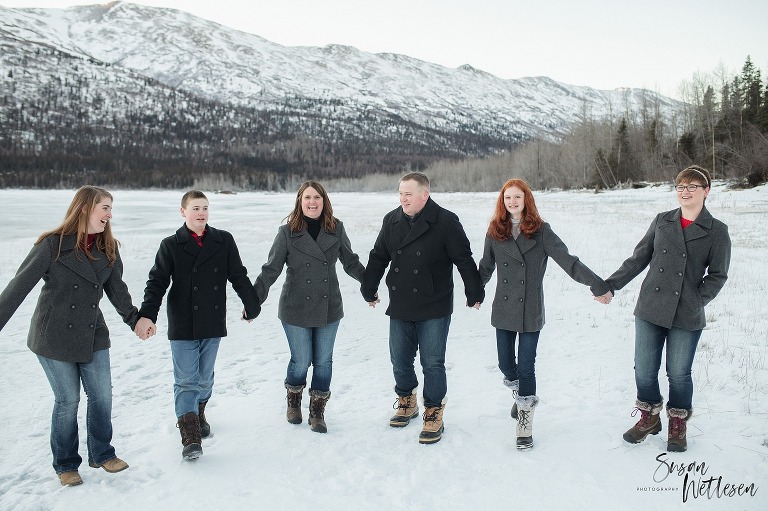 Family holds hands during winter family session