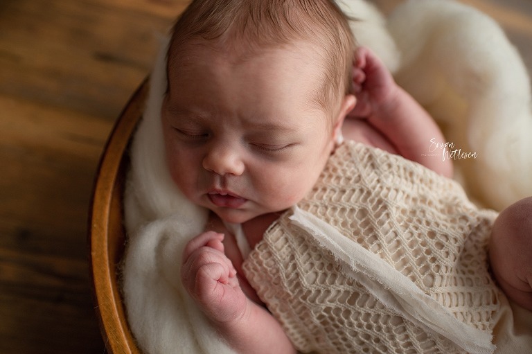 baby sleeps in white outfit during Alaska Classic Newborn Portrait Session