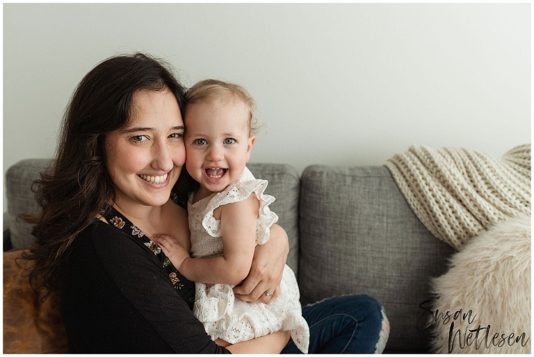 Mom holds baby up near face and both smile during Alaska Motherhood Session